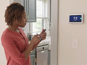 Professional AC System Inspection Technician inspecting multiple American Standard air conditioning units