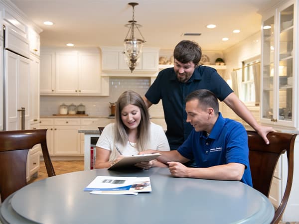 Energy Efficient Air Conditioning & Heating Installation Technician installing high efficiency HVAC system