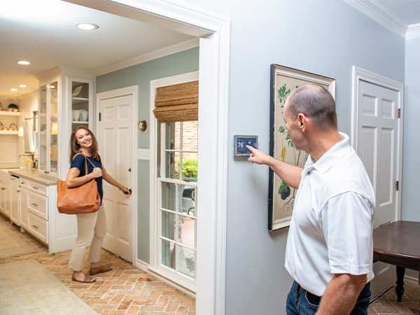 Professional AC System Inspection Technician inspecting multiple American Standard air conditioning units