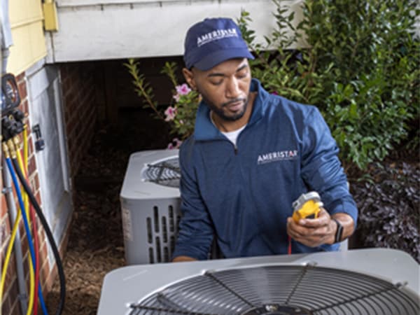 Professional HVAC Tune-Up and Inspection HVAC technician checking pressure gauges during AC system inspection